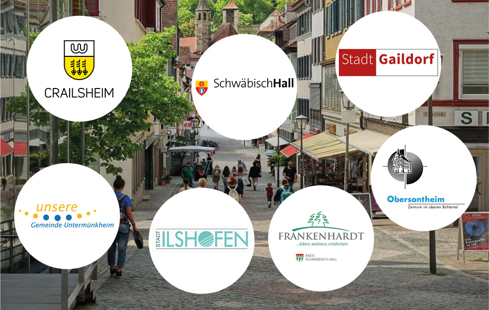 Stadtbild mit den Wappen der Kommunen im Vordergrund